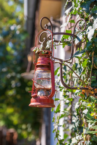 istock A single old red kerosene lantern hanging against a garden background, Hungary 2201284051