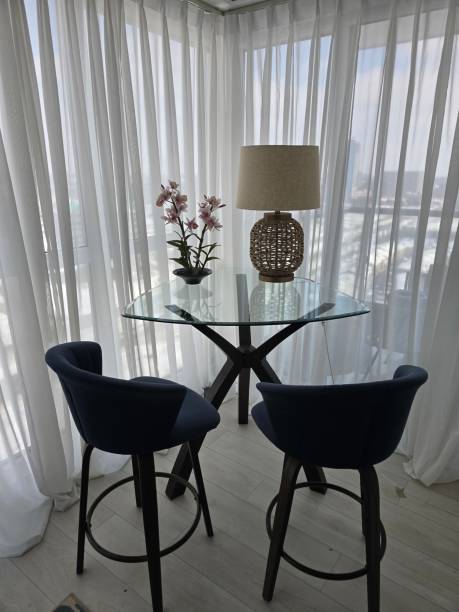 istock Elegant Modern Dining Corner with Glass Table and Velvet Bar Stools 2201287789