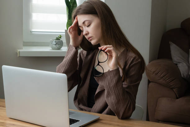 istock Female office worker, freelancer taking off glasses tired of computer work. Suffering from headache, eye strain, concentration issues 2201287836