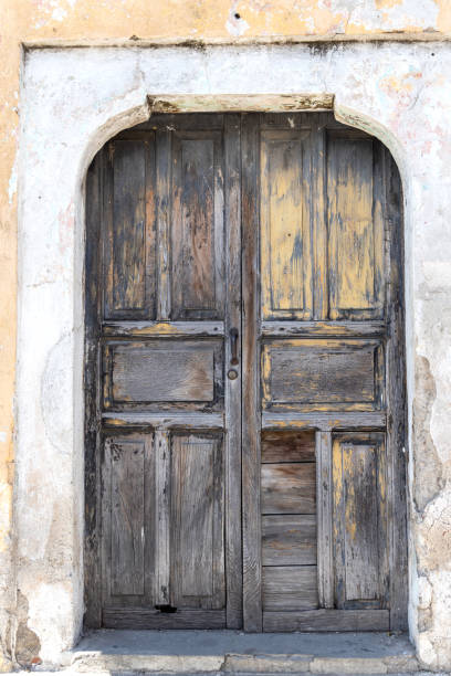Old wooden door detail with squares and metal studs