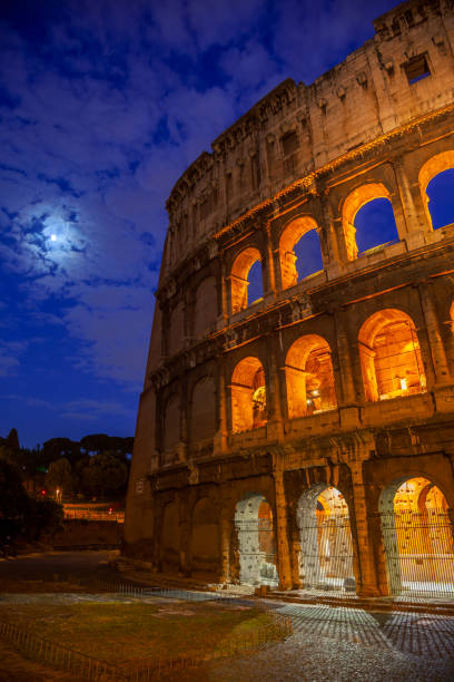 Italy. Moonlit summer night in Rome. The Colosseum illuminated at night