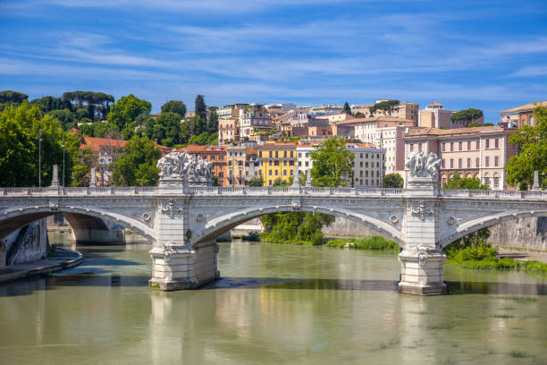 Italy. Sunny summer day in Rome. Victor Emmanuel II Bridge over the Tiber River and surrounding buildings