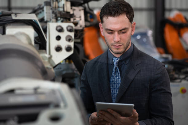 istock Business or engineer Caucasian male use tablet computer checking robot arm 2201296704