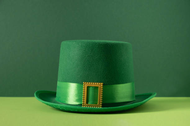 St Patricks day and March 17 concept with green parade Leprechaun Hat with belt and buckle on green background. Close up.