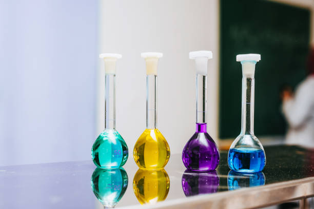 A modern laboratory setup with colorful chemical reactions in glass test tubes. The image highlights the precision and innovation in scientific research, showcasing transparent liquids and laboratory equipment in a controlled environment.