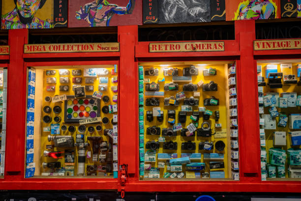 People shopping and browsing in the colourful Portobello Market and antique shops in the heart of London, UK.