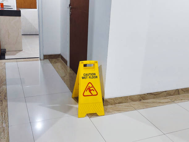 istock Yellow Caution Wet Floor Sign in a Clean Indoor Hallway Environment 2201310474
