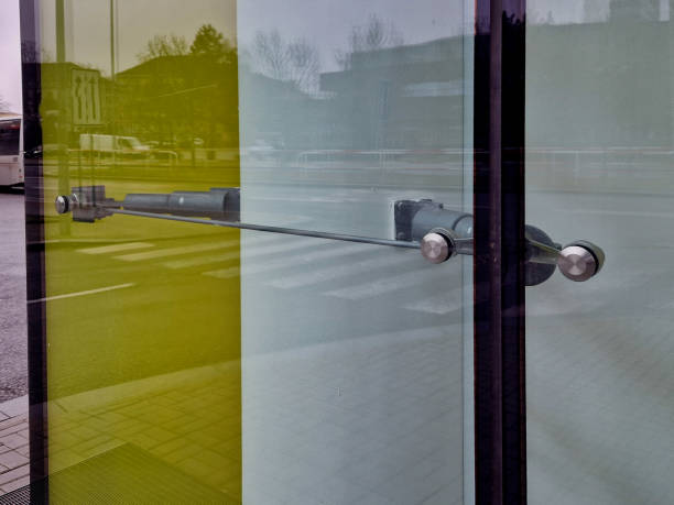 the glass is attached to the wall using screws and washers intended for drilling into glass. the cladding is a railing and an air partition in the station hall