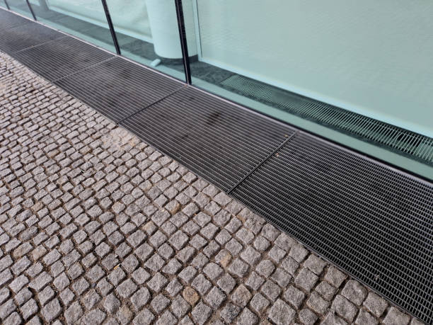 istock Ventilation grate along the house. basement windows are below ground level. Metal walking grid. foundation ventilation and drainage for removing moisture from masonry and bricks. recessed light, mesh 2201310680
