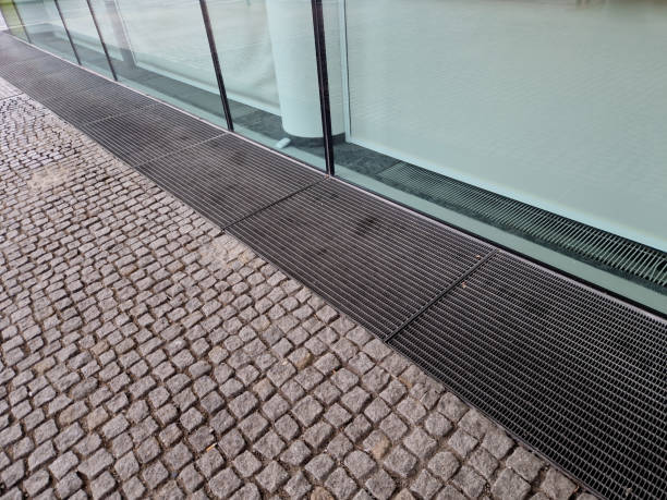 istock Ventilation grate along the house. basement windows are below ground level. Metal walking grid. foundation ventilation and drainage for removing moisture from masonry and bricks. recessed light, mesh 2201310681