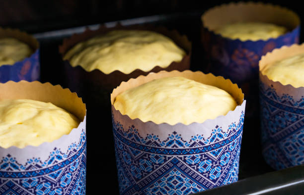 Sour dough for Easter baking in the paper form in the oven. Cakes for Easter. Close-up. Selective focus.