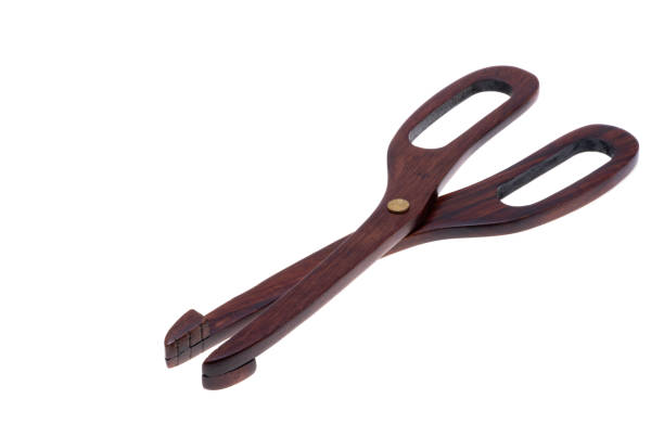 Two gray plastic clothespins on white towel.