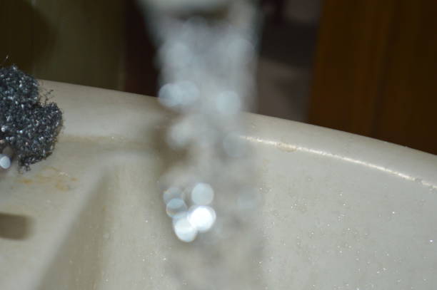 istock Water flowing from the tap in the kitchen. Shallow depth of field. 2201317475