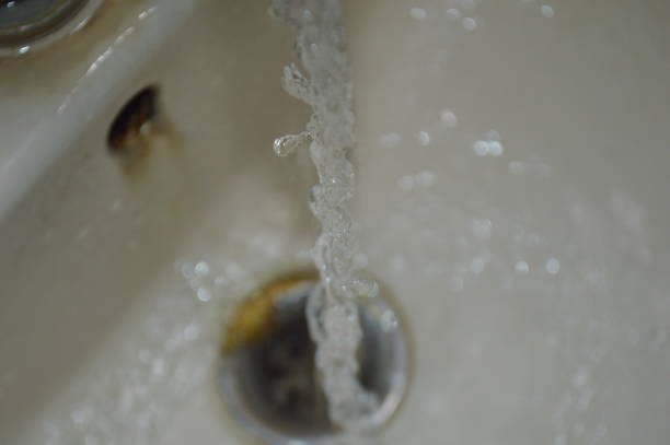 istock Water flows from the faucet in the bathroom. Close up 2201317508