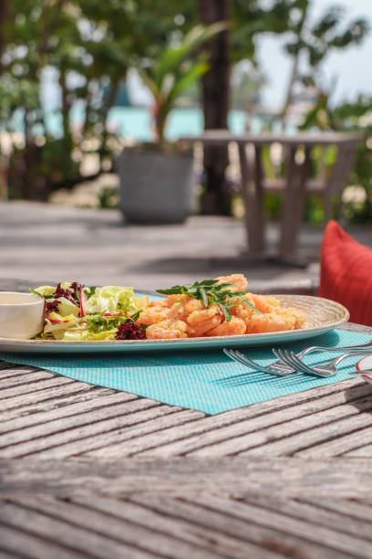 istock Beach Side restaurant shack serving lunch food snacks with prawns and bruschetta bread in tropical Maldives island resort 2201319934