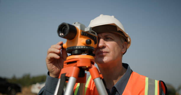 istock A senior male engineer is using a survey camera to measure levels on a construction site. Civil engineer utilizes a survey camera 2201324539