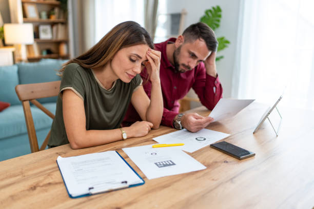 istock Worried couple having problems with their financial bills at home 2201325183
