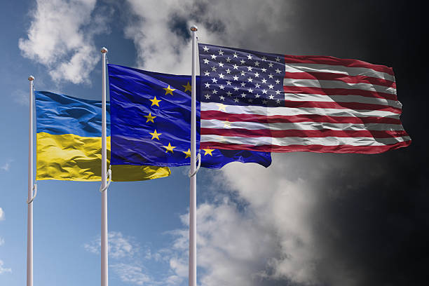 istock Ukraine, EU and USA flags above dark sky 2201326154