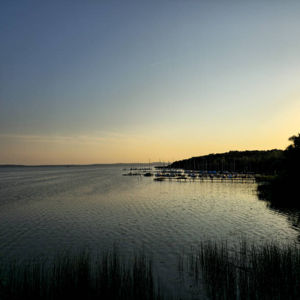 istock A stunning and tranquil lakeside sunset showcases boats gliding over serene reflections 2201330286