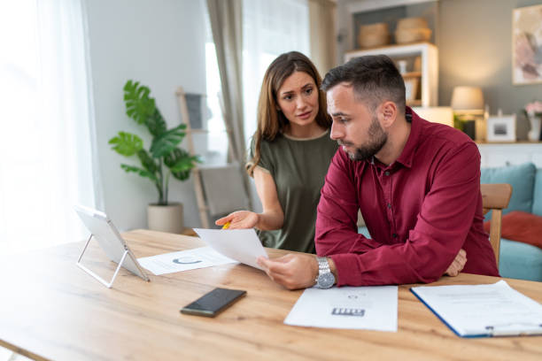istock Displeased couple having problems with financial bills at home 2201331480