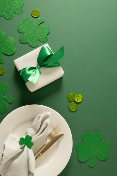 istock St Patrick's Day party table setting with green decoration on green background. 2201334507
