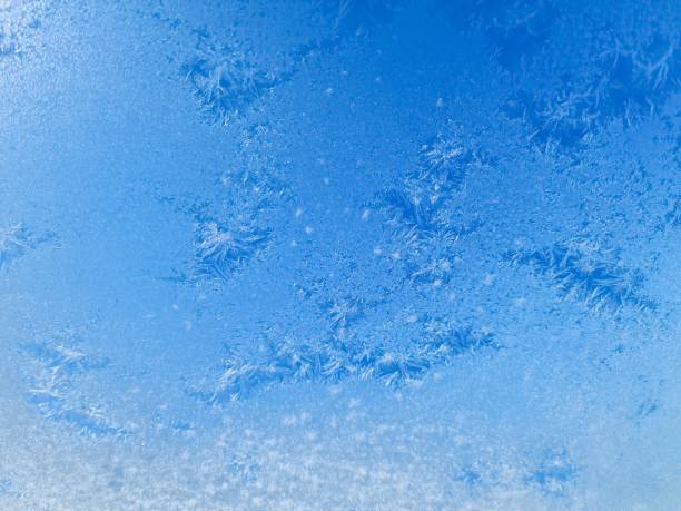 istock Ice crystals creating beautiful frozen patterns on window in winter 2201335632