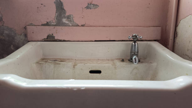 istock Dirty hand basin in a neglected building. 2201335748