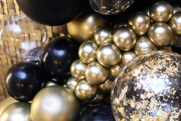 istock Decorative birthday photo wall. Gold and black balloons texture. 2201340560