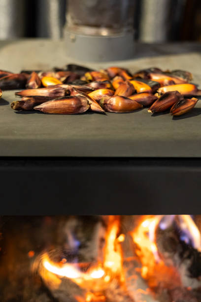 istock Pinhao - Araucaria pine nuts - roasting on a wood stove 2201343043