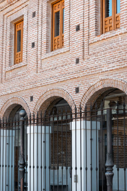 istock Intricate brick architecture showcases arched windows and decorative fencing in a historical district during daytime 2201343253