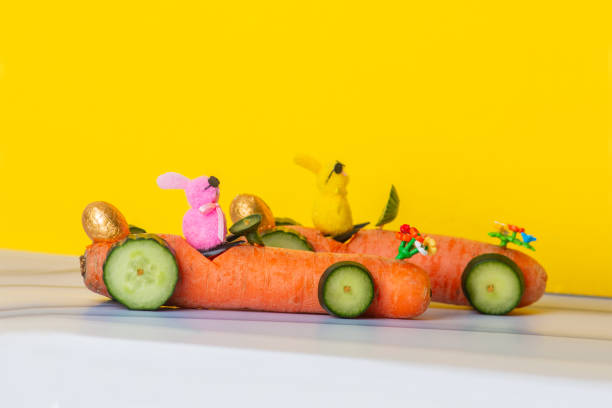 The big carrot race rally 2025Carrot race between pink and yellow Easter bunny wearing fashionable sunglasses with dark lenses, who will win the race? Exciting carrot racing cars, cucumber wheels and a golden Easter egg on the back of the racing car
