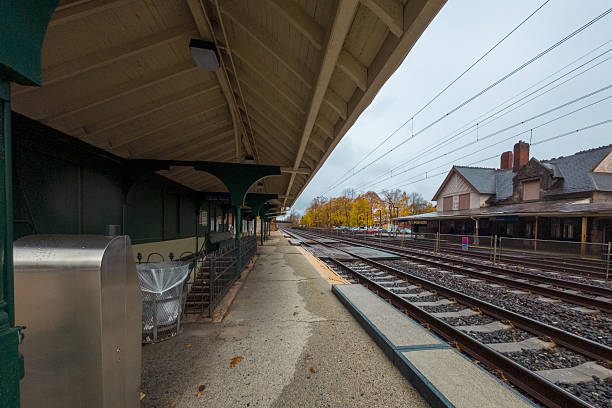 Devon, PA. USA - Nov 21th 2024: A Devon train station with a lot of empty tracks. The station is empty and the sky is cloudy