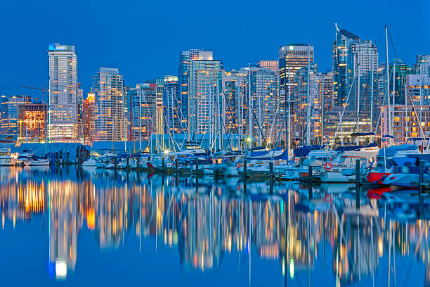 Evening view of Downtown Vancouver from Coal Harbor and Burrard Inlet, British Columbia