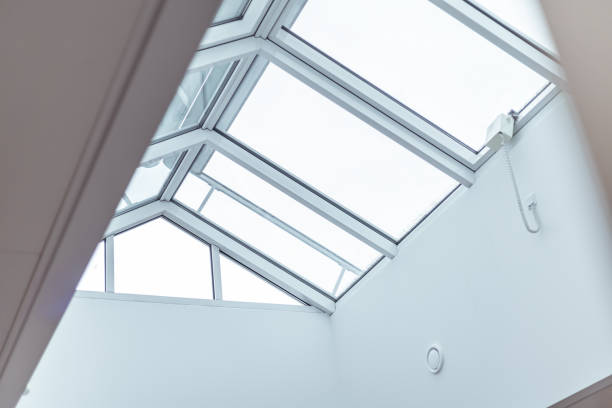 istock Skylight structure brings natural light into modern indoor space with white walls and minimalistic design 2201366590