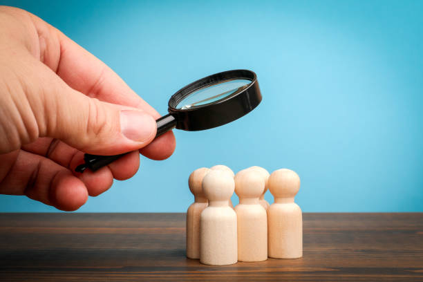 istock Recruitment and search concept. Miniature figures on a wooden table 2201385200