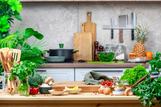 istock From farm to table: rustic kitchen with organic goodness, food background. Oak cutting board with vegetables, herbs, mushrooms and linen towel on cozy kitchen with wooden table, kitchenware and ingredients 2201387703