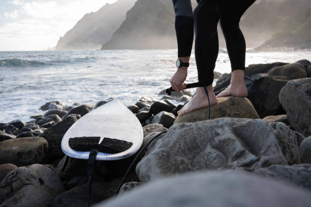 Mature man goes surfing at sunset. Getting away from it all.