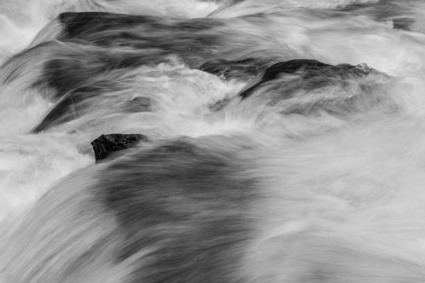A long exposure image that blurs the motion of a flowing river.