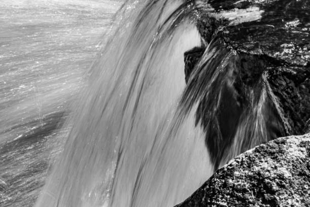 A long exposure image that blurs the motion of a flowing river.