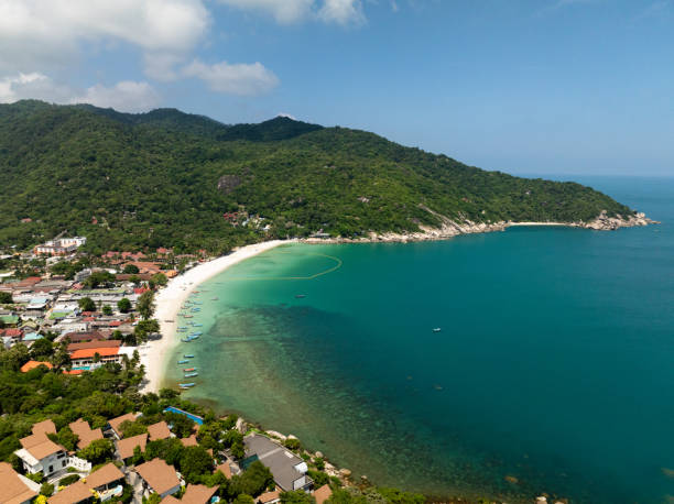 Turquoise bay with a sandy beach and lush surroundings. Ko Pha Ngan, Thailand.