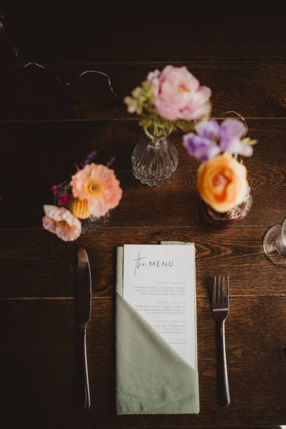 istock Top down photo of menu and flowers place setting 2201398997