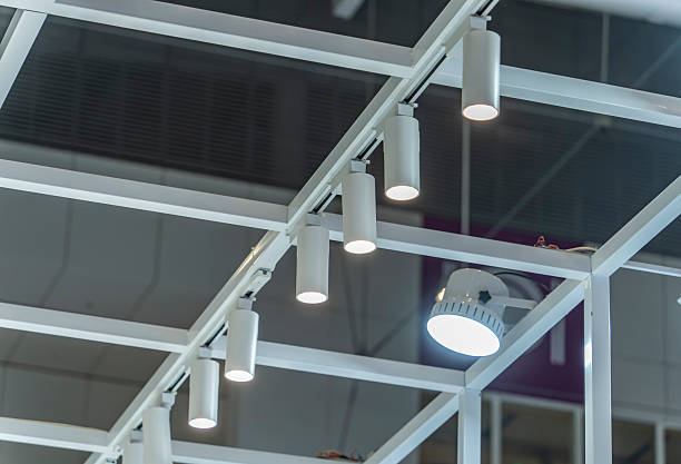 istock Directional LED lights on rails under the ceiling in a modern warehouse, shopping center building, office or other commercial real estate object. 2201402569