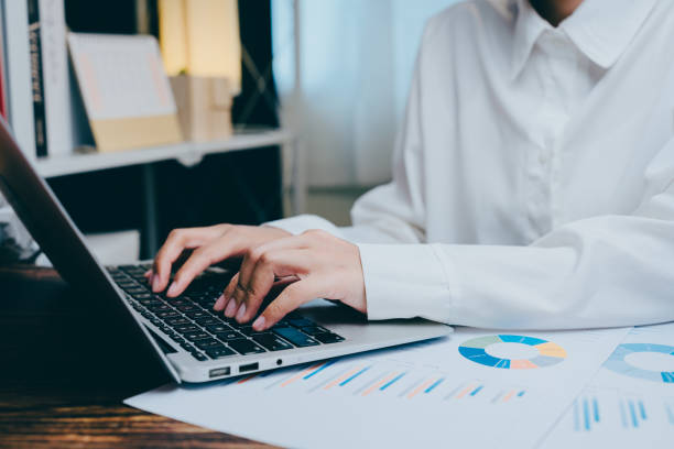 istock Business professional working on laptop with graphs and charts ?, business concept 2201408923