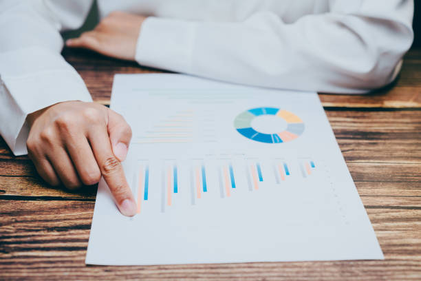 istock Detailed Chart Analysis with Hand Pointing to Business Data, business concept 2201408958