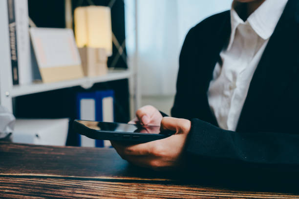 istock Business Professional Using Smartphone in Modern Office Setting, business concept 2201409092