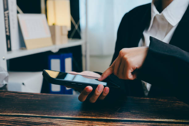 istock Professional Business Person Using Smartphone in Modern Office Setting, business concept 2201409098