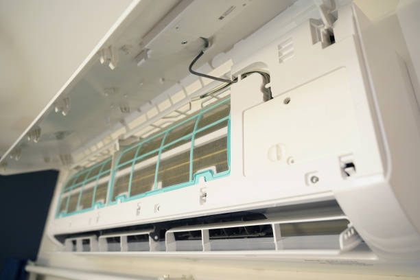 istock The worker cleans and repairs the air conditioner to ensure it operates properly 2201409394