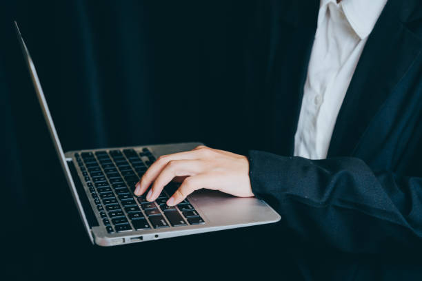 istock Person in Formal Attire Using Laptop in Dark Environment, business concept 2201413552
