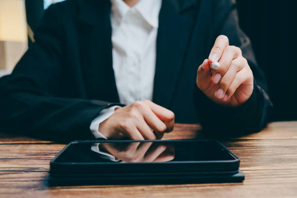 istock Business Professional Holding Cigarette Near Digital Device, business concept 2201413804