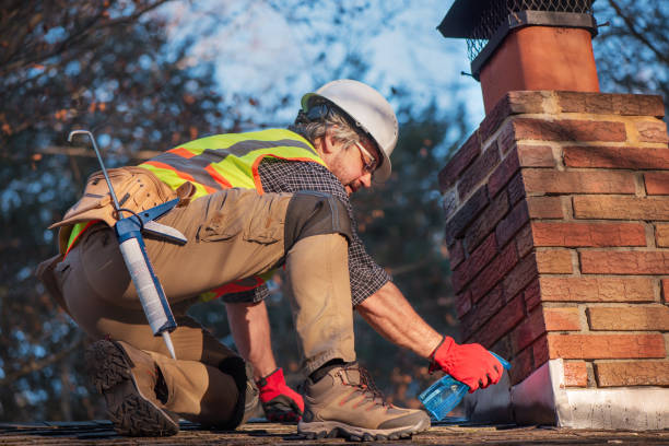 istock Roofer sprays water on brick chimney. Worker prepares cement application wearing white hard hat and safety gear 2201414520